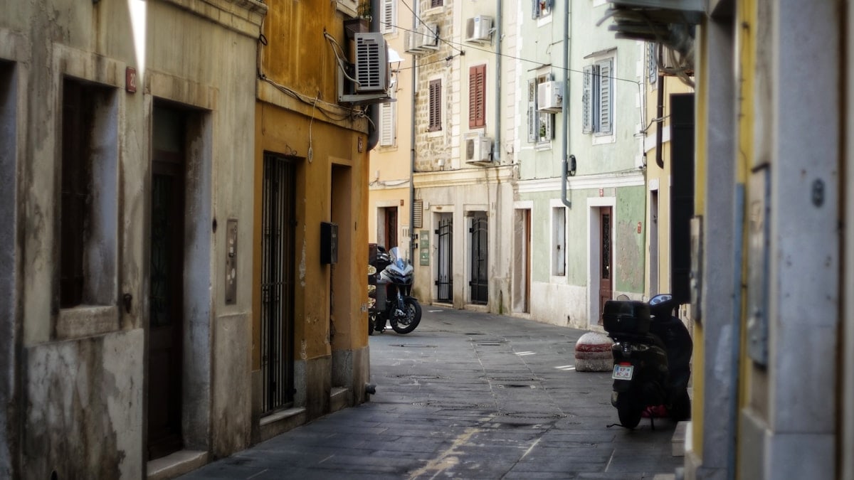 motorcycles parked in an alley